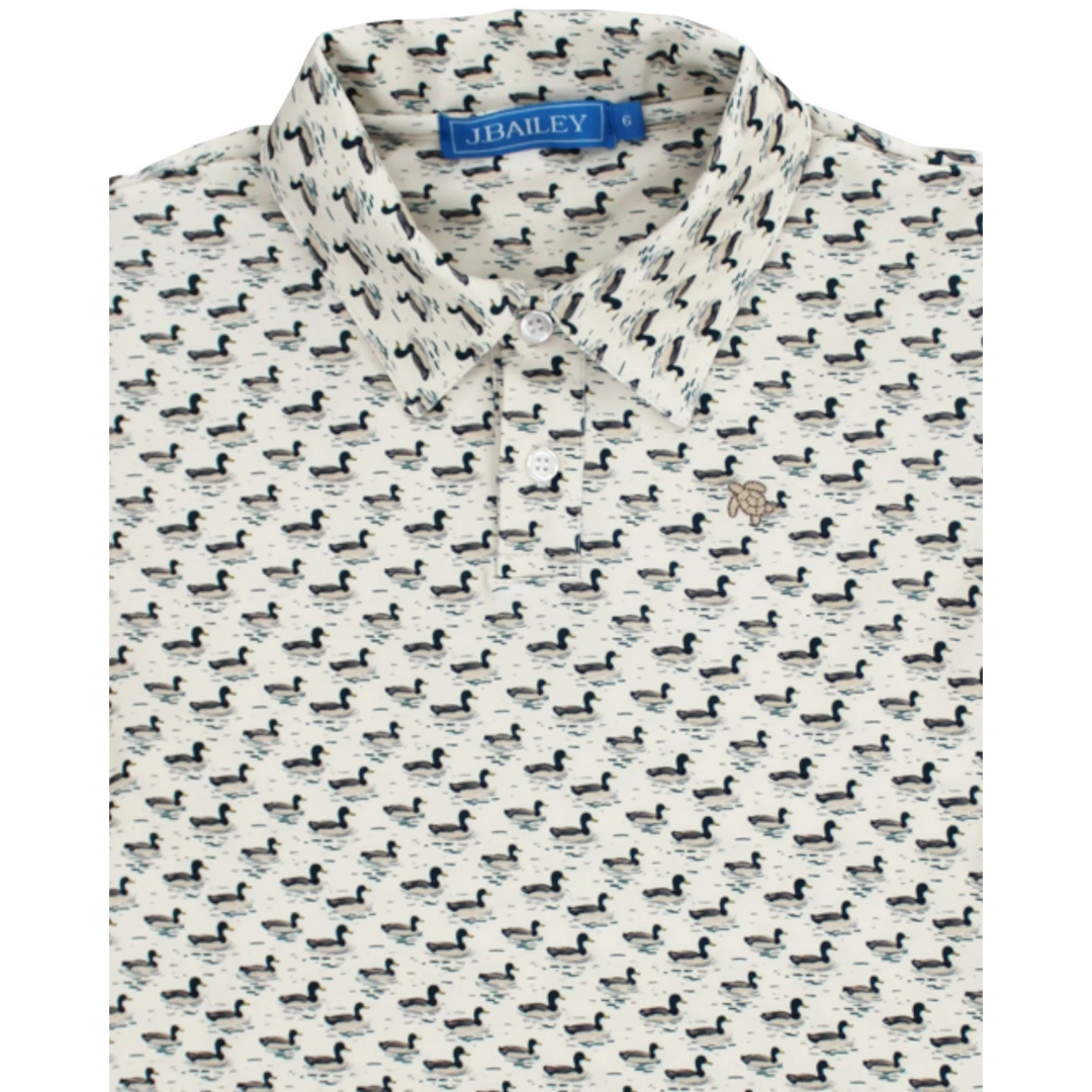 That Store boys performance polo in cream with an allover mallard duck print and classic collar