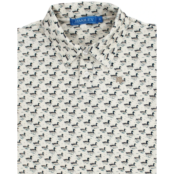 That Store boys performance polo in cream with an allover mallard duck print and classic collar