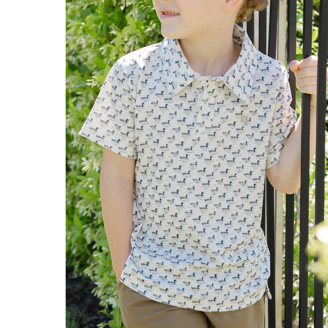 That Store boys performance polo in cream with a mallard duck print, featuring a classic collar and lightweight fabric