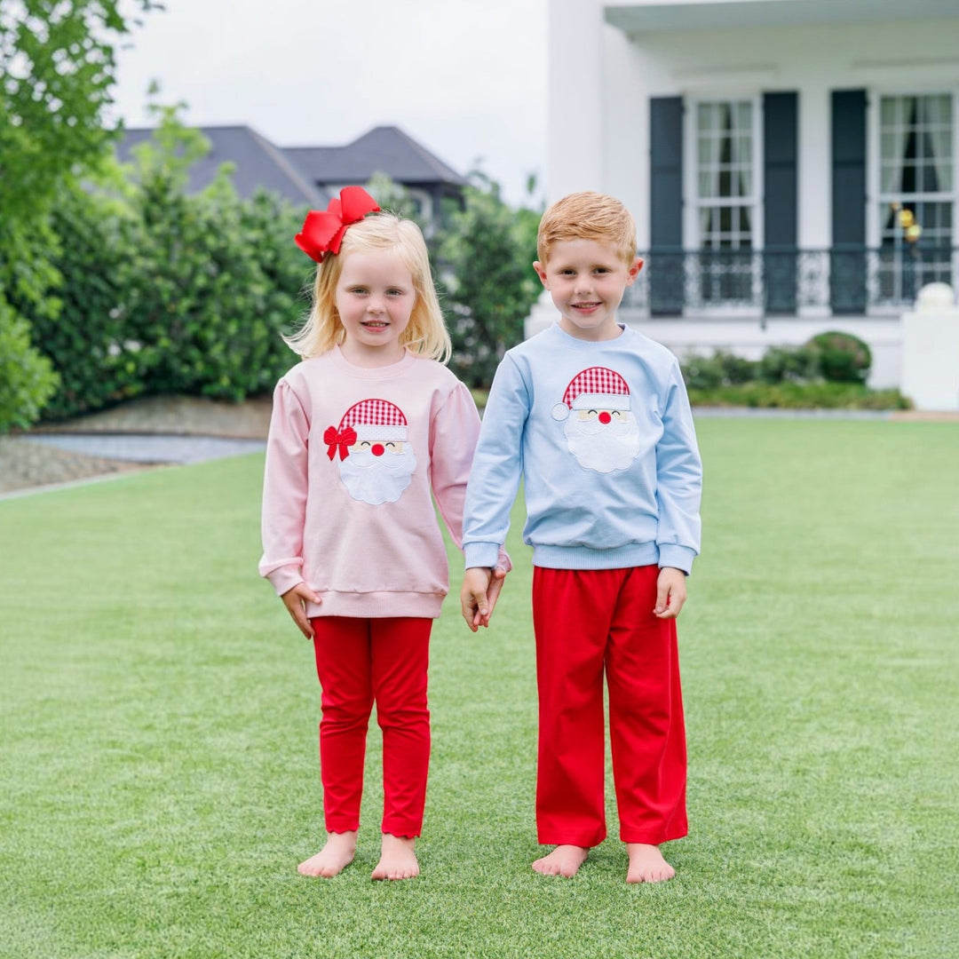 That Store boys light blue French terry pullover with Santa applique worn by a child standing next to a sister