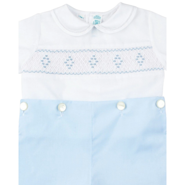 That Store boys bobby suit featuring a white smocked bodice with blue diamond embroidery and light blue pants.