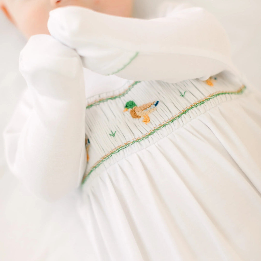 That Store baby boy footie in white Peruvian Pima cotton with mallard duck smocking detail on the chest