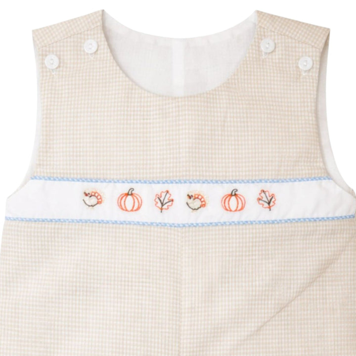 That Store brown gingham jon jon for boys featuring embroidered fall pumpkins, leaves, and turkeys on the chest.