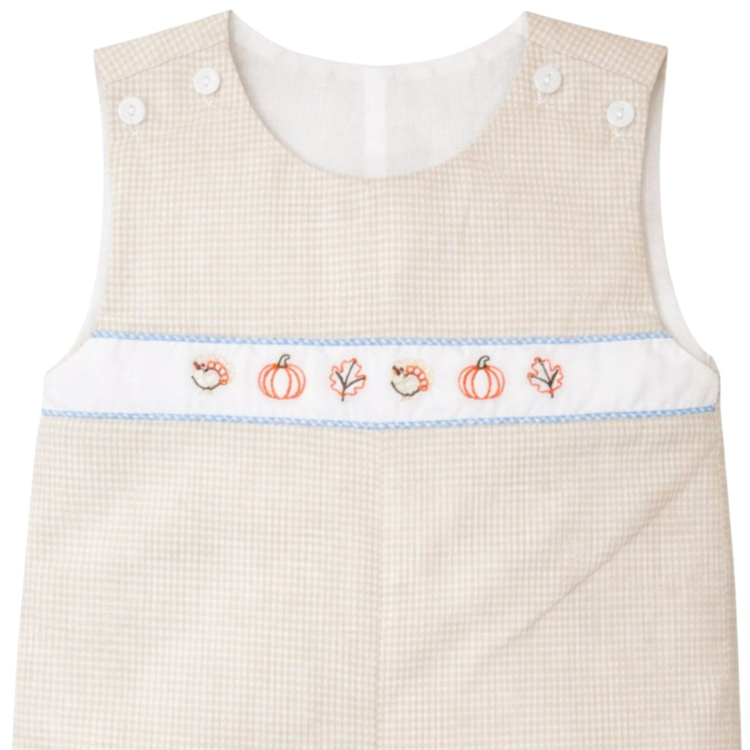 That Store boys brown gingham jon jon with embroidered fall leaves, pumpkins, and turkeys on a white chest panel.