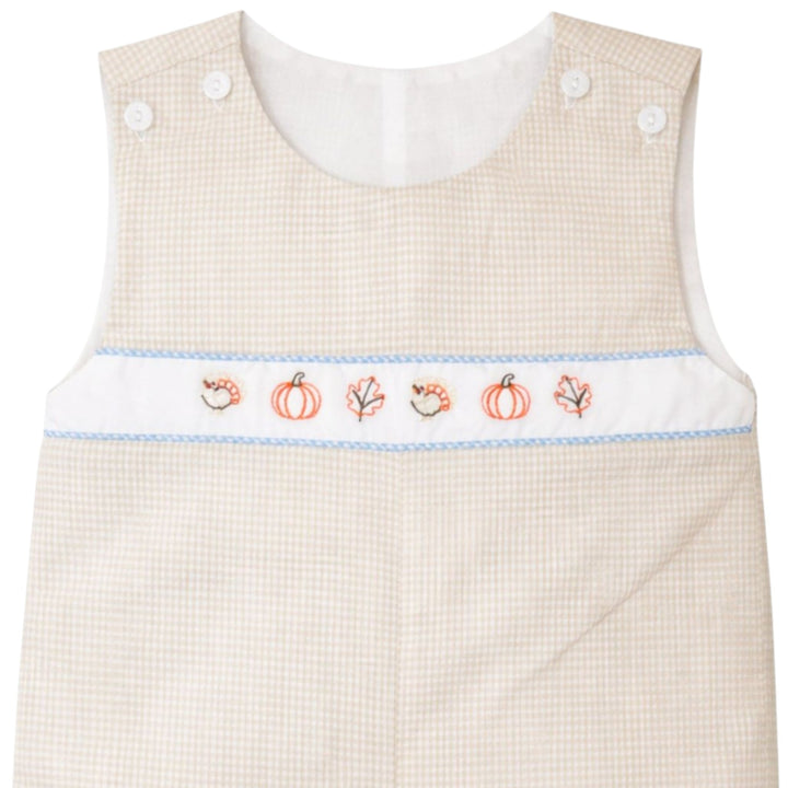 That Store boys brown gingham jon jon with embroidered fall leaves, pumpkins, and turkeys on a white chest panel.