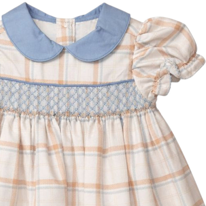 That Store girls brown aspen plaid dress with blue geometric smocking and a peter pan collar and puff sleeves.