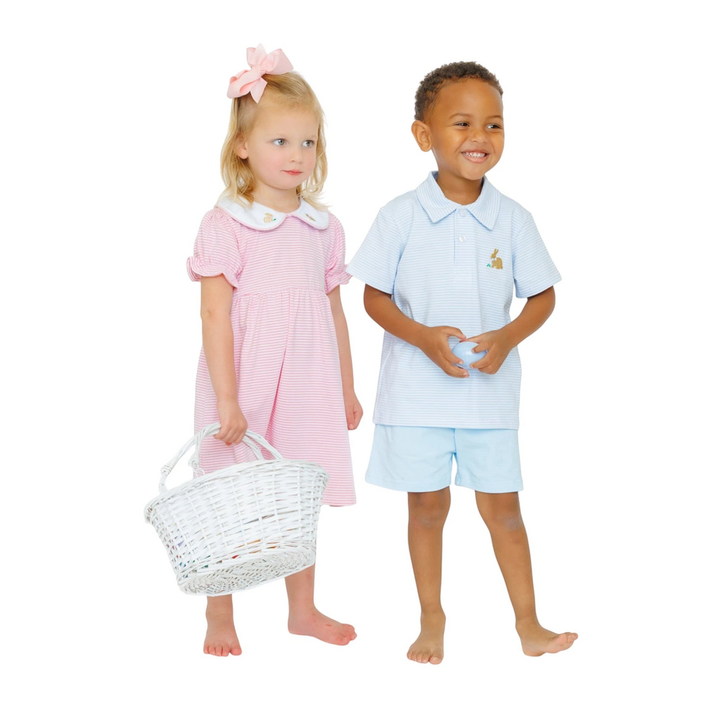 That Store blue striped polo shirt with bunny embroidery worn by a smiling boy next to a girl in a pink dress
