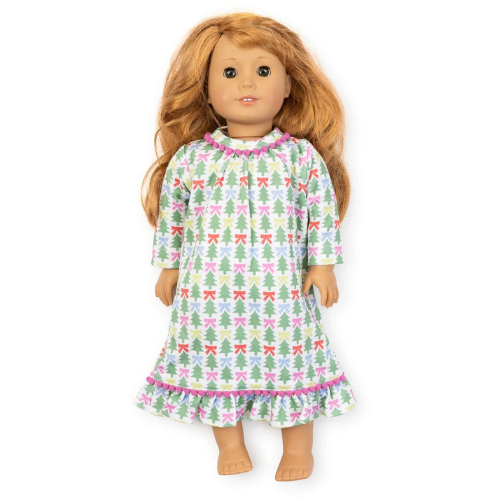 That Store Carlin doll dress in white Pima cotton with green Christmas tree and colorful bow print and pom-pom trim.