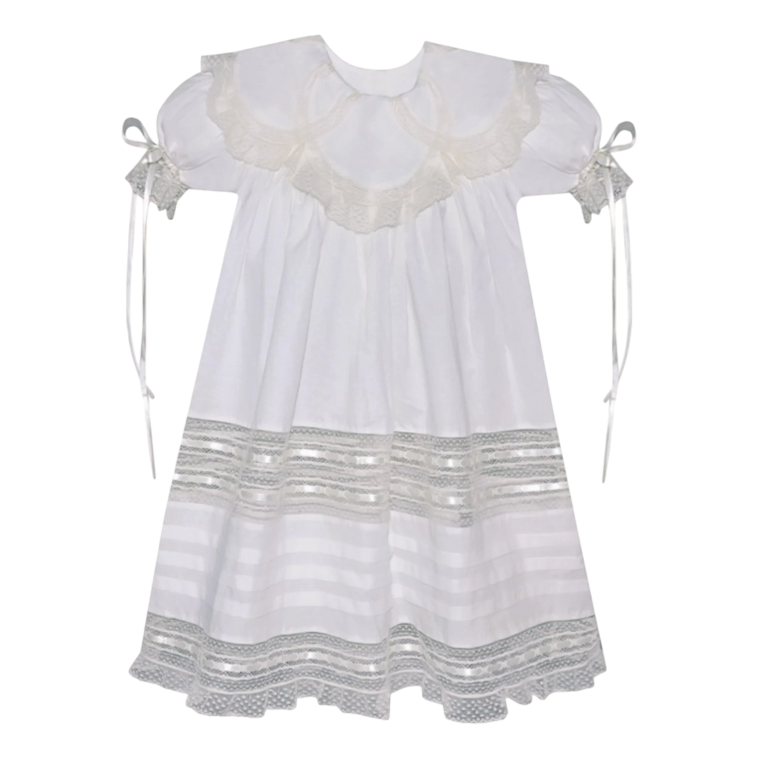 That Store Charlie dress in vintage white with ecru lace, featuring a petal collar and satin ribbon sleeve ties.
