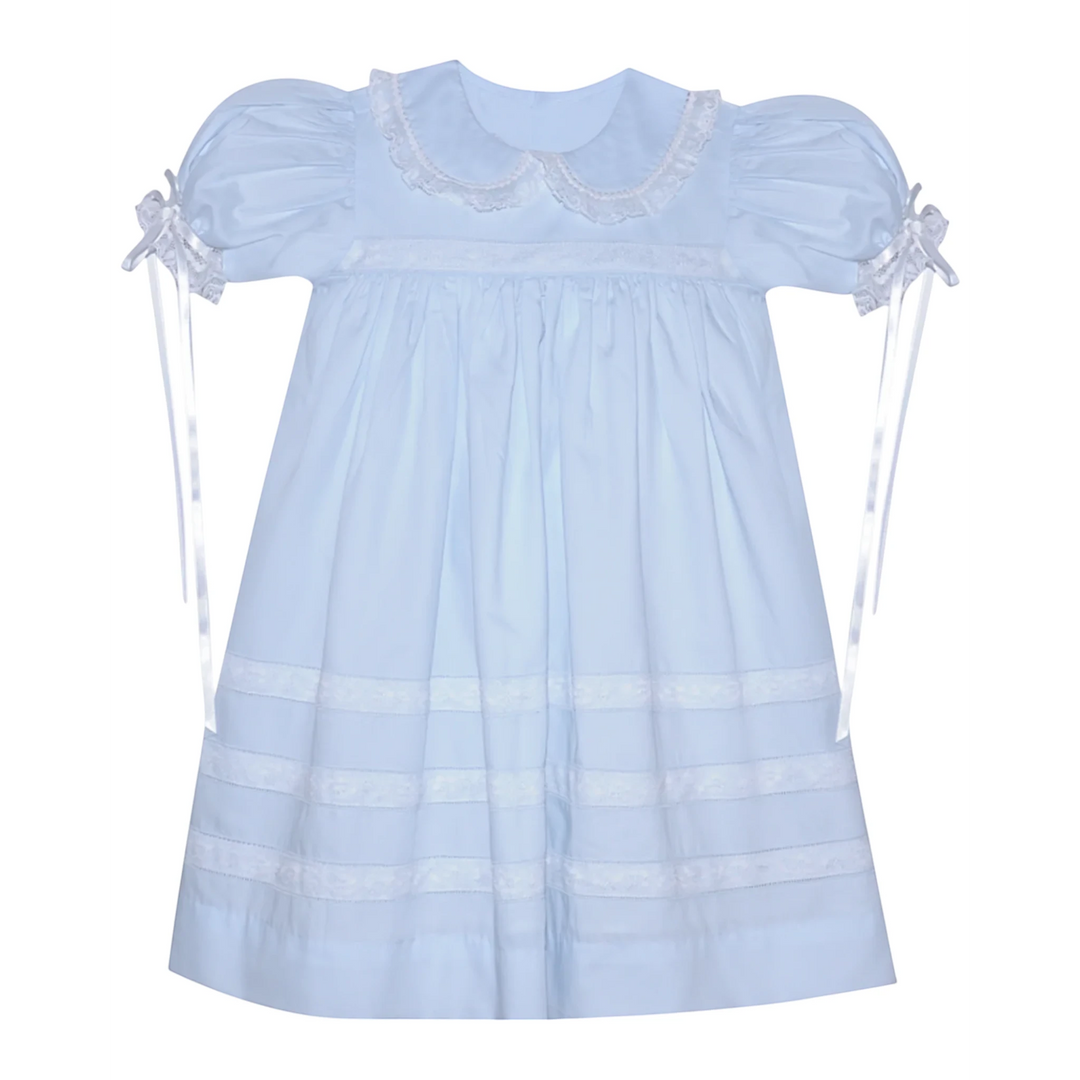 That Store Constance blue heirloom dress with white lace puff sleeves, collar, and ribbon ties.