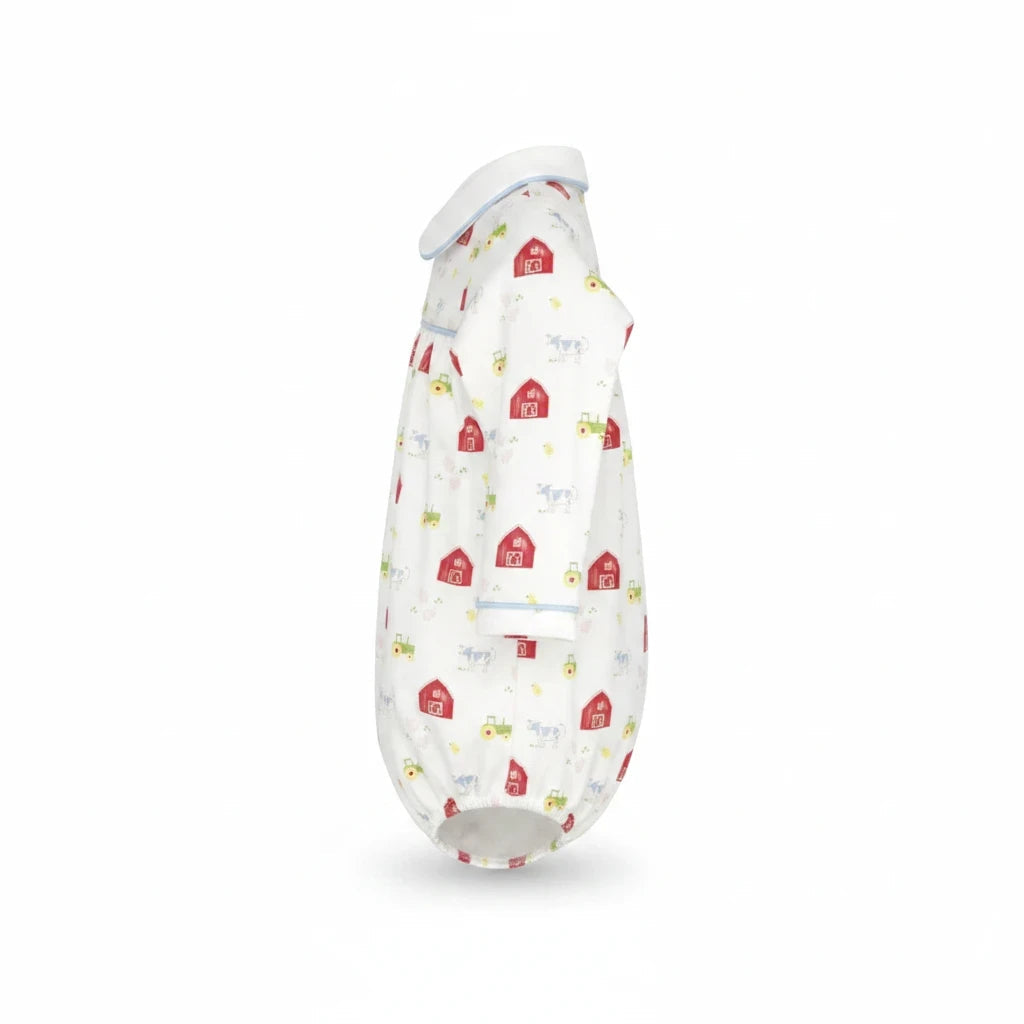 That Store Covington bubble in white knit fabric with a red barnyard tales print and light blue piping details.