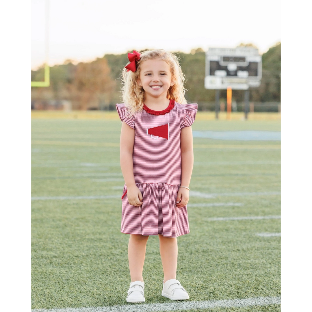 That Store crimson and white striped dress with megaphone applique worn by a young girl on a football field