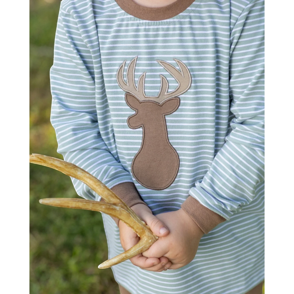That Store boys long sleeve shirt with green stripes and a brown deer applique, held by a child in an outdoor setting.