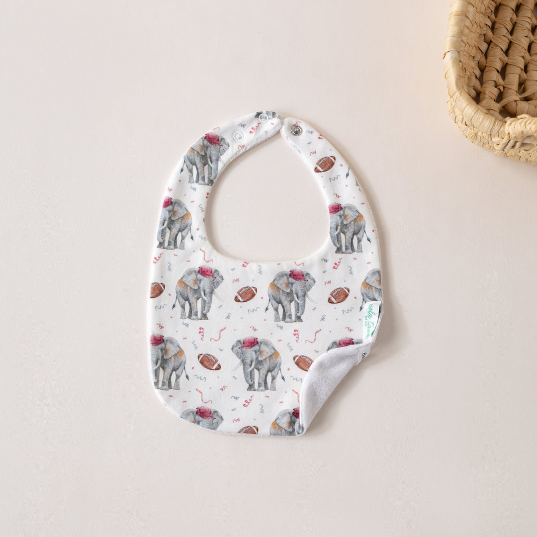 That Store organic cotton baby bib featuring an elephant and football print with an absorbent terrycloth back