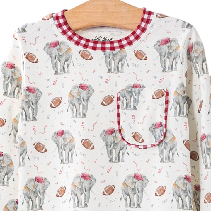 That Store organic cotton kids pajamas featuring an elephant and football print with red gingham trim on a hanger