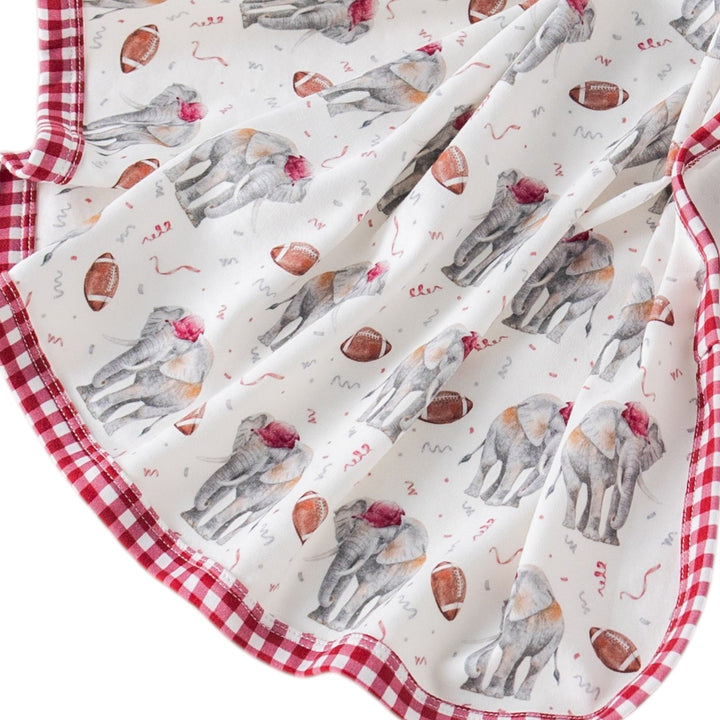 That Store organic cotton muslin swaddle blanket featuring elephant and football print with red gingham trim