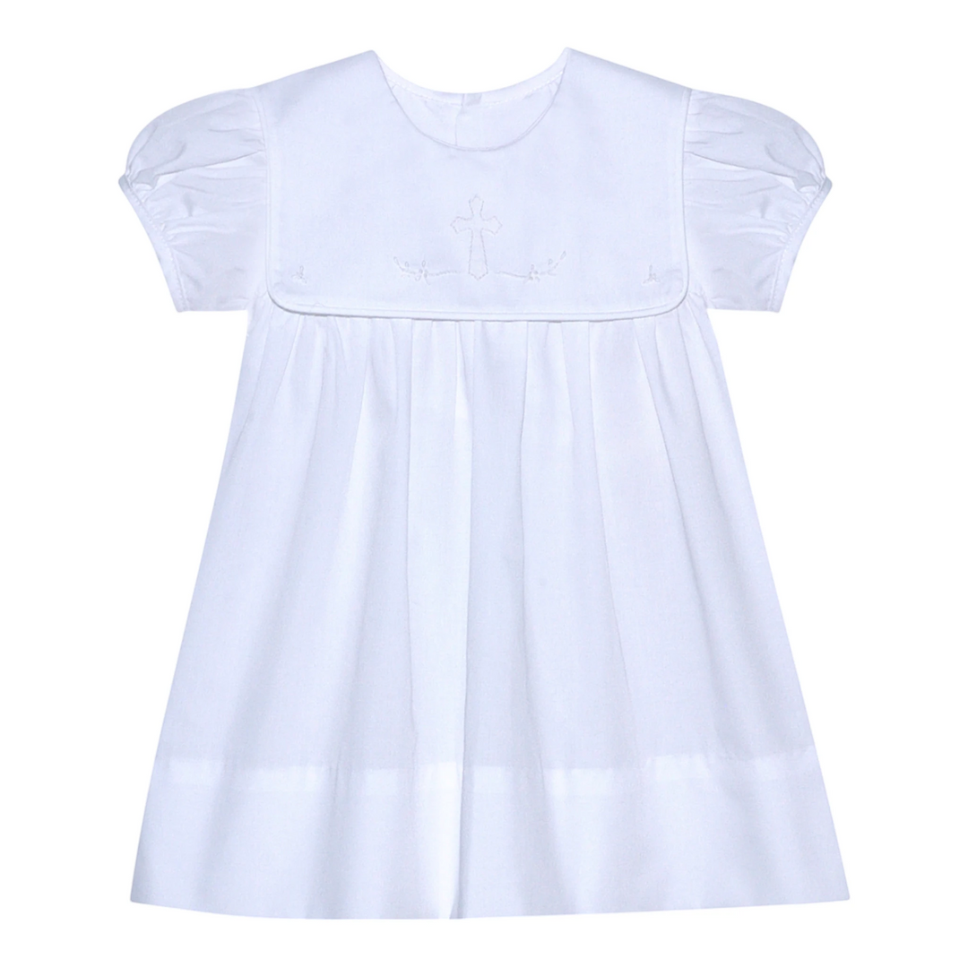 That Store Ellis Cross white dress with puff sleeves and delicate shadow stitched ecru cross detail.
