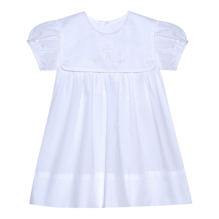 That Store Ellis Cross white dress with puff sleeves and delicate shadow stitched ecru cross detail.