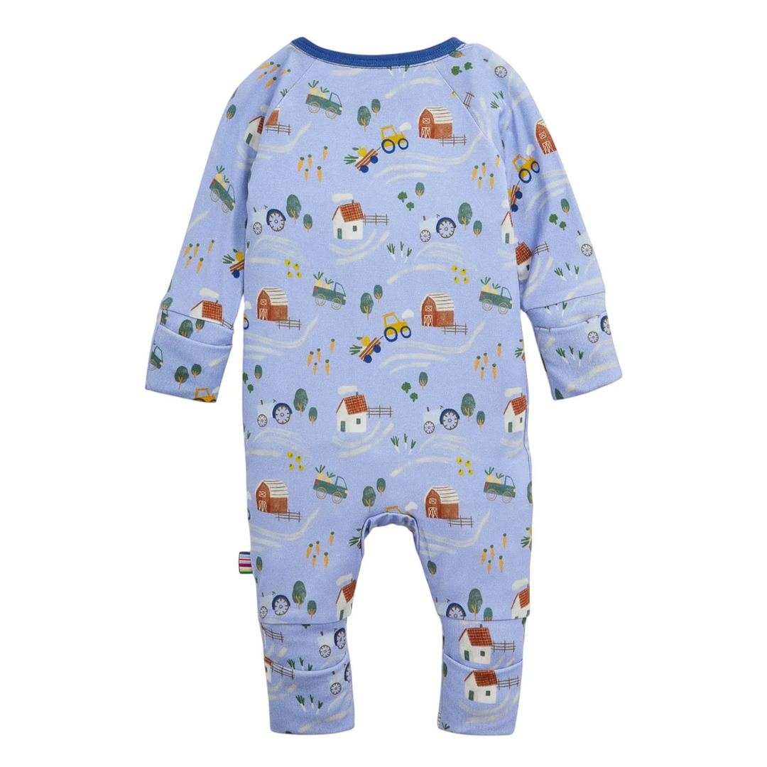 That Store baby coverall in light blue modal fabric with a farm-themed print, featuring magnetic closures and cuffs.
