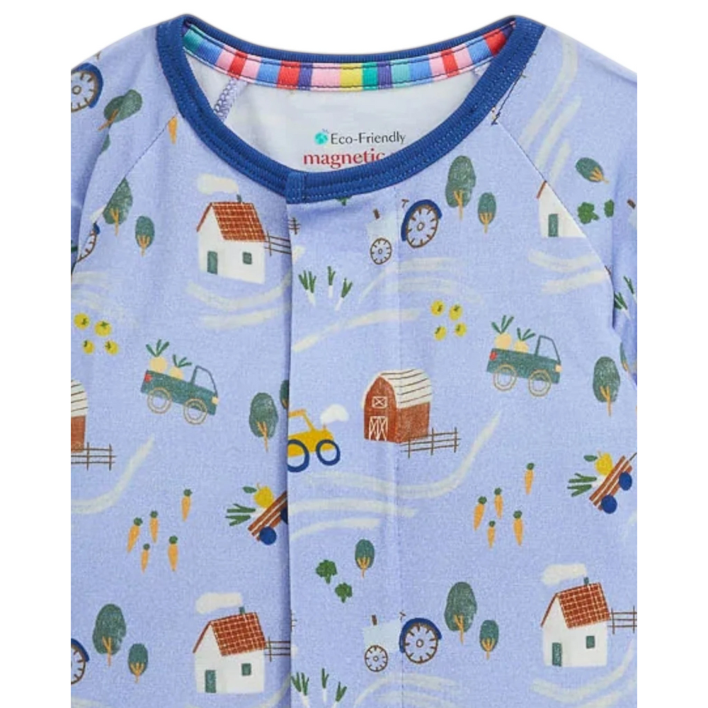 That Store Farm To Cradle modal baby coverall in light blue with a colourful farm print and magnetic closure detail.