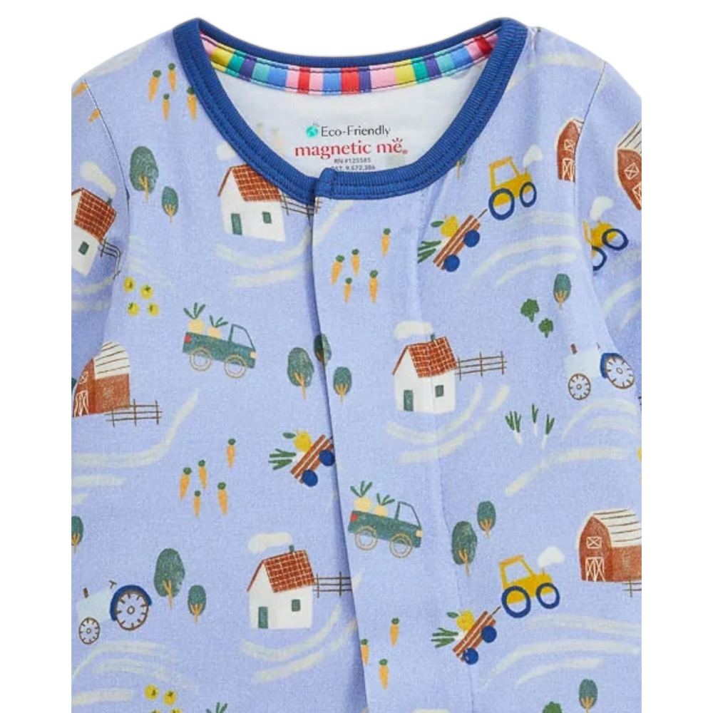 That Store Farm To Cradle modal baby footie in light blue with a colorful farm print and magnetic front closure.