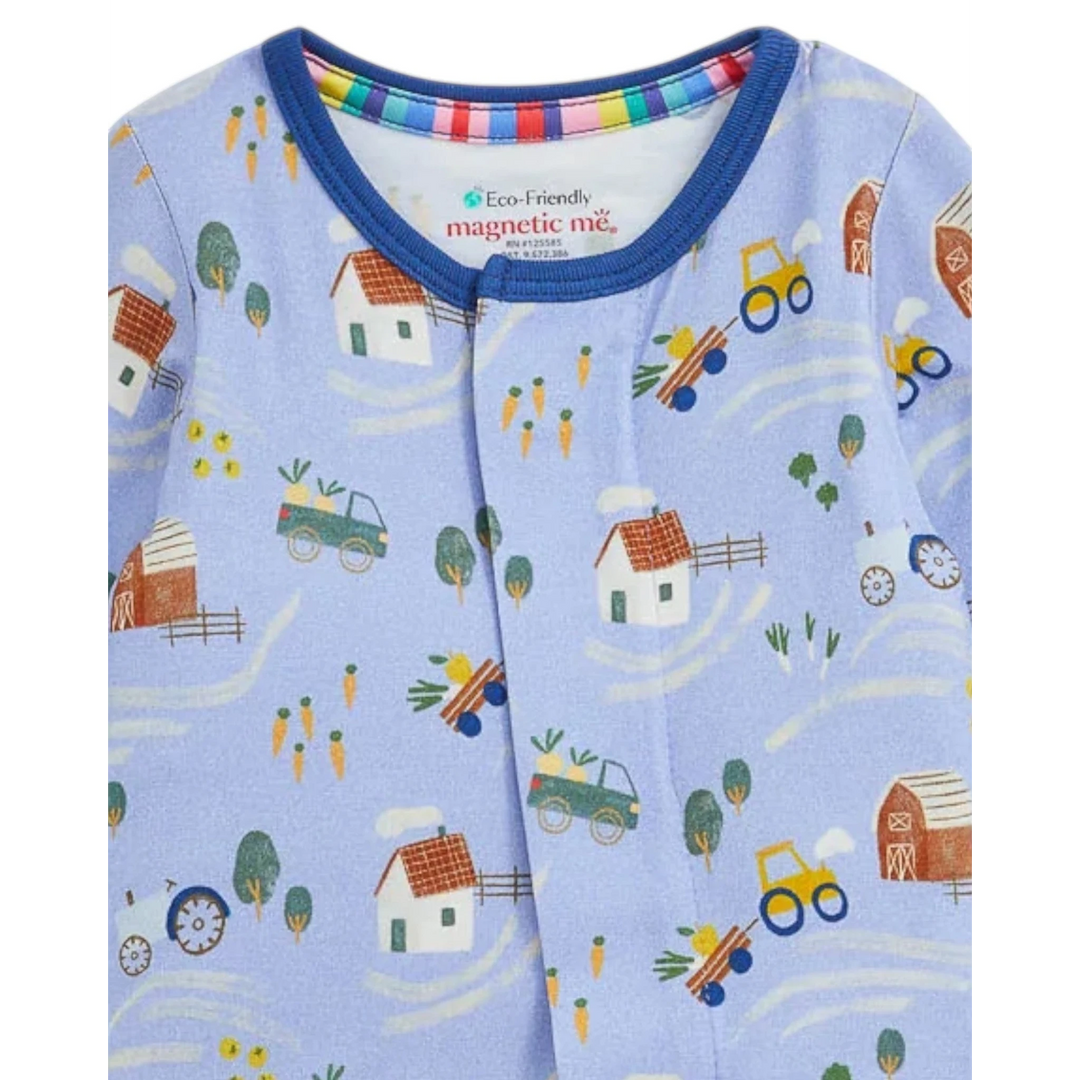 That Store Farm To Cradle modal baby footie in light blue with a colorful farm print and magnetic front closure.