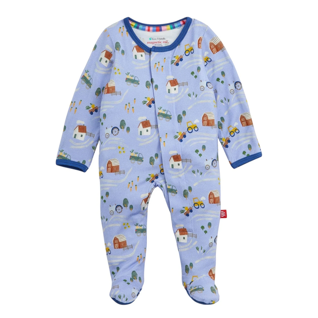 That Store Farm To Cradle modal baby footie in light blue with a farm-themed print and magnetic front closures.