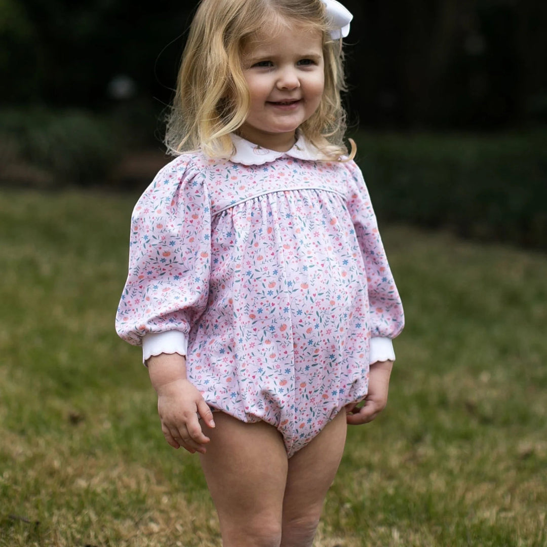 That Store girls bubble romper in Pumpkin Grove floral print with long sleeves, white collar, and pumpkin embroidery.
