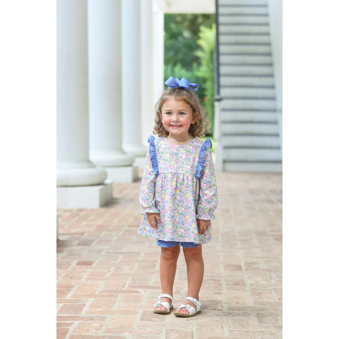 That Store floral girls bloomer set with ruffled long-sleeve top and blue bloomers worn by a smiling toddler