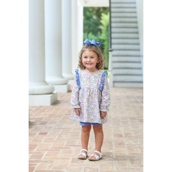 That Store floral girls bloomer set with ruffled long-sleeve top and blue bloomers worn by a smiling toddler