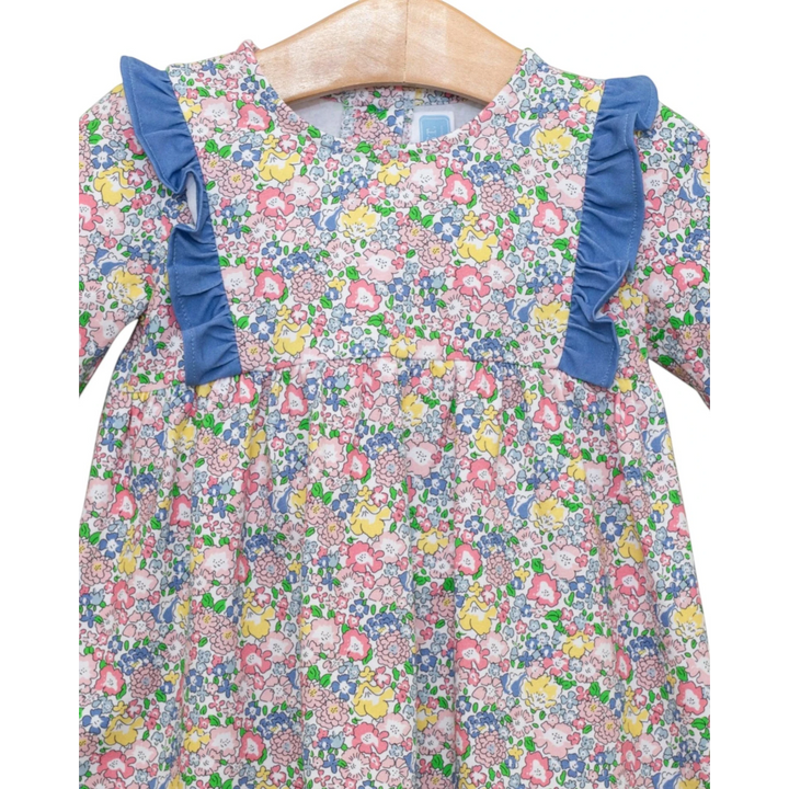 That Store floral girls top with blue ruffle shoulders and long sleeves, perfect for a cozy autumn outfit.
