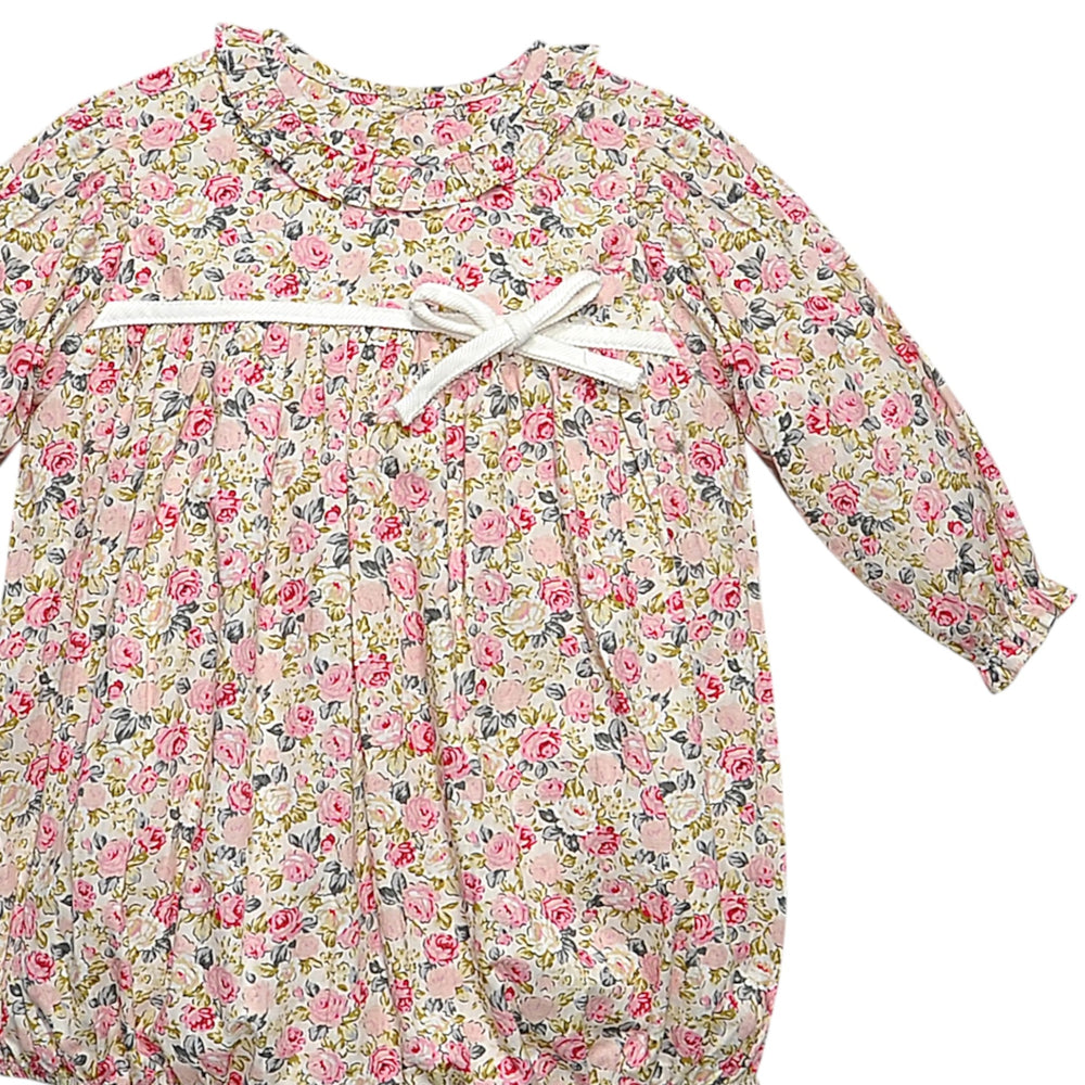 That Store girls bubble featuring a vintage pink rose floral print, ruffled collar, and a white ribbon bow detail.