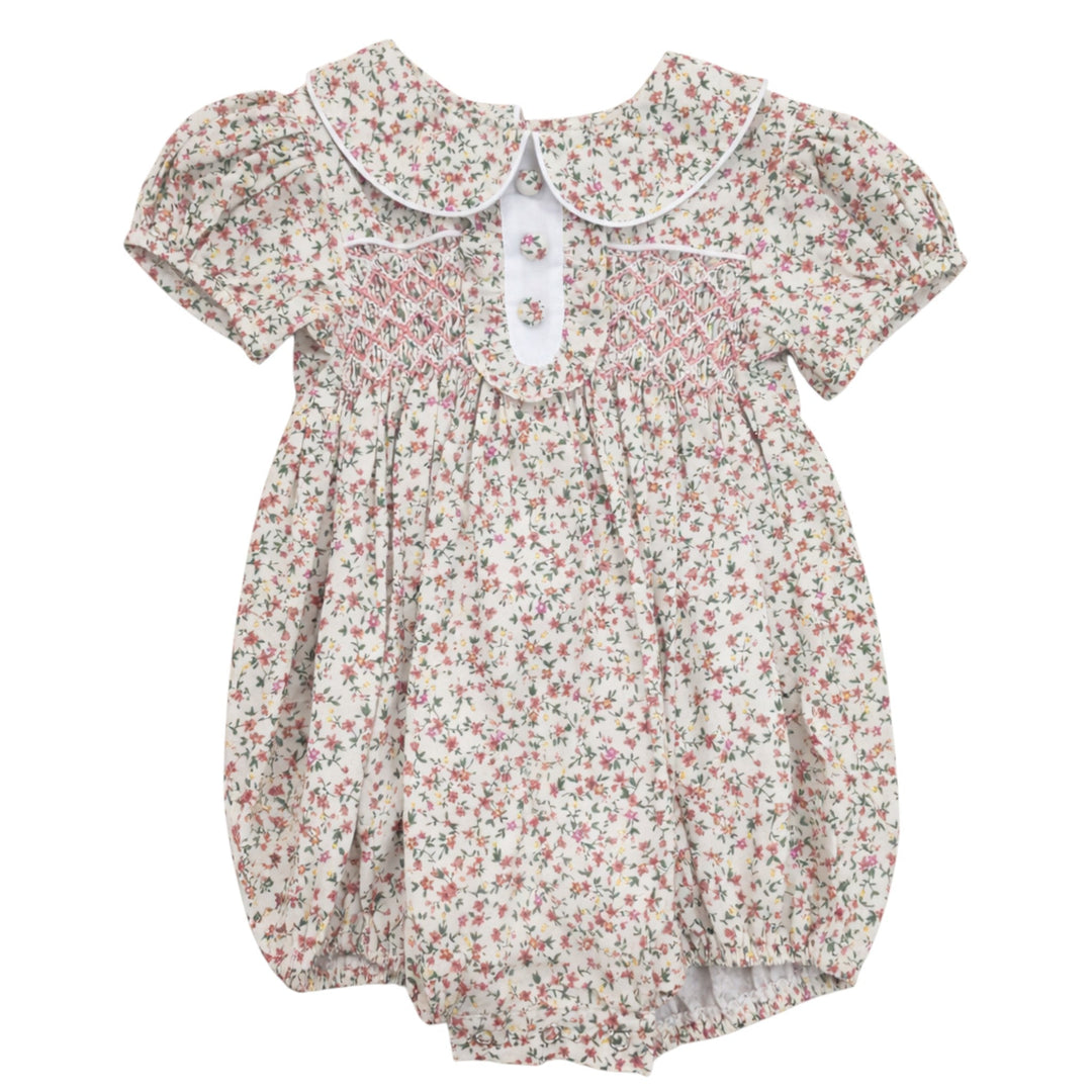 That Store girls pink floral cotton bubble with classic chest smocking, peter pan collar, and short puff sleeves.