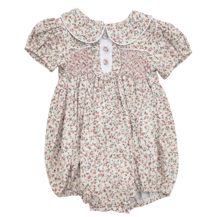 That Store girls pink floral cotton bubble with classic chest smocking, peter pan collar, and short puff sleeves.