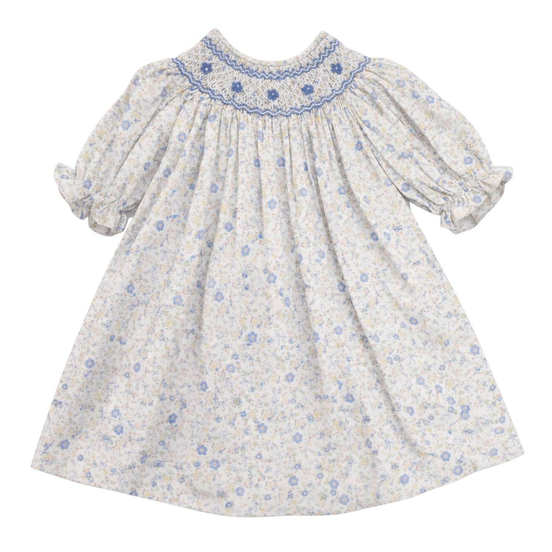 That Store girls cotton dress featuring blue and yellow bow floral print with classic blue smocking on the chest.