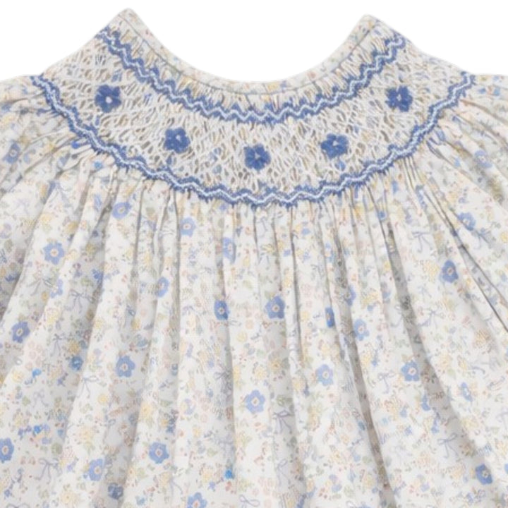 That Store girls cotton dress with blue and yellow floral bow print and intricate blue smocking on the chest