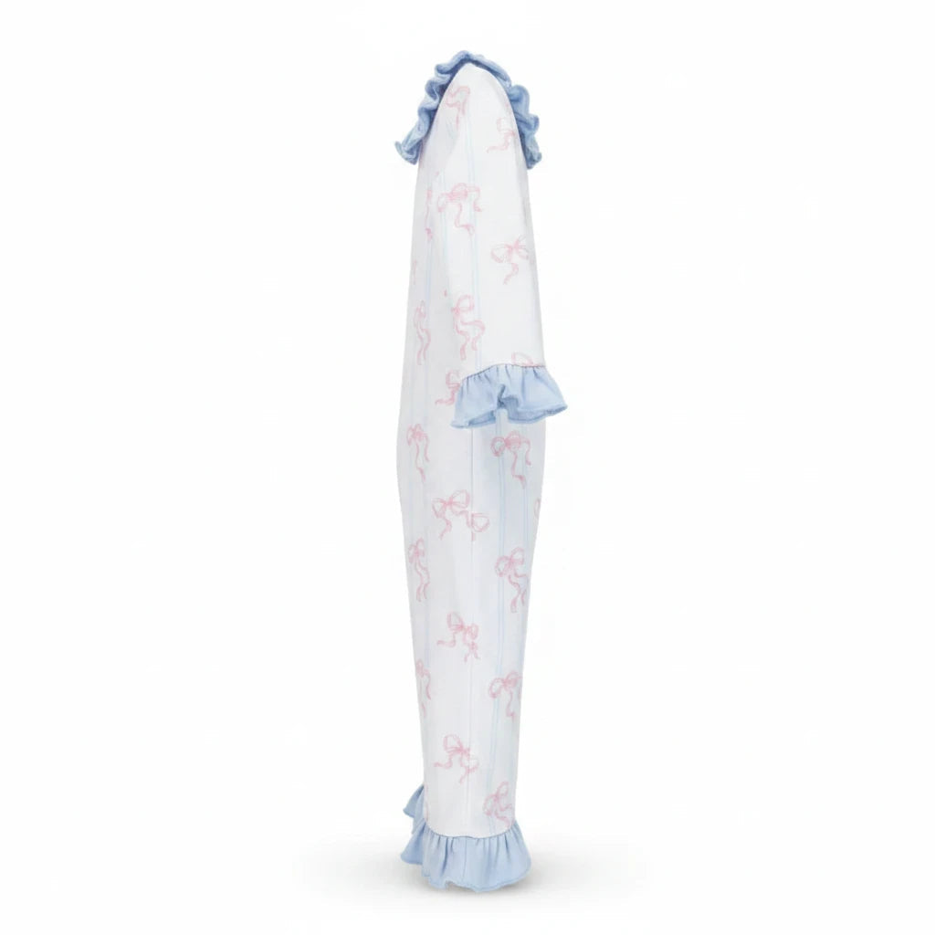 That Store girls Riley romper in white with pink bow print, featuring blue ruffled trim on sleeves and hem.