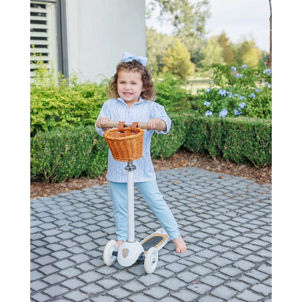 That Store Vineyard Blooms girls 1/4 zip pullover and pants set in light blue floral cotton on a child with a scooter