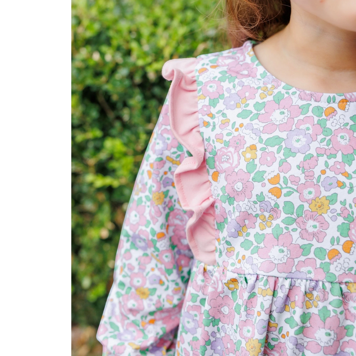 That Store girls pink floral cotton pant set featuring ruffled shoulders and a soft long-sleeve bodice