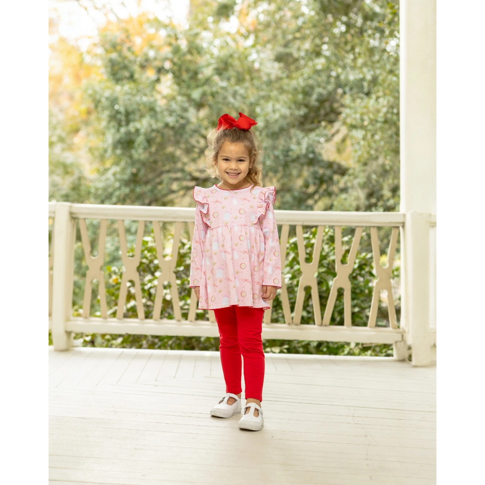 That Store Milk & Cookies girls pants set with pink ruffle top and red leggings on a young girl with a red hair bow
