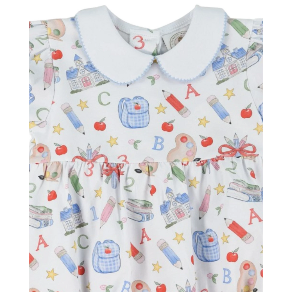 That Store girls bubble featuring a white fabric with a colorful school supply print and a blue peter pan collar.