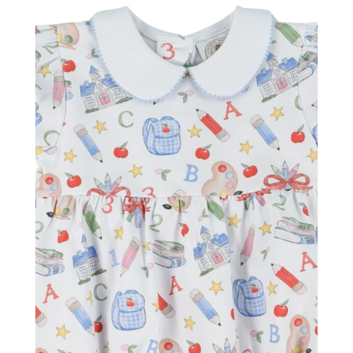 That Store girls bubble featuring a white fabric with a colorful school supply print and a blue peter pan collar.