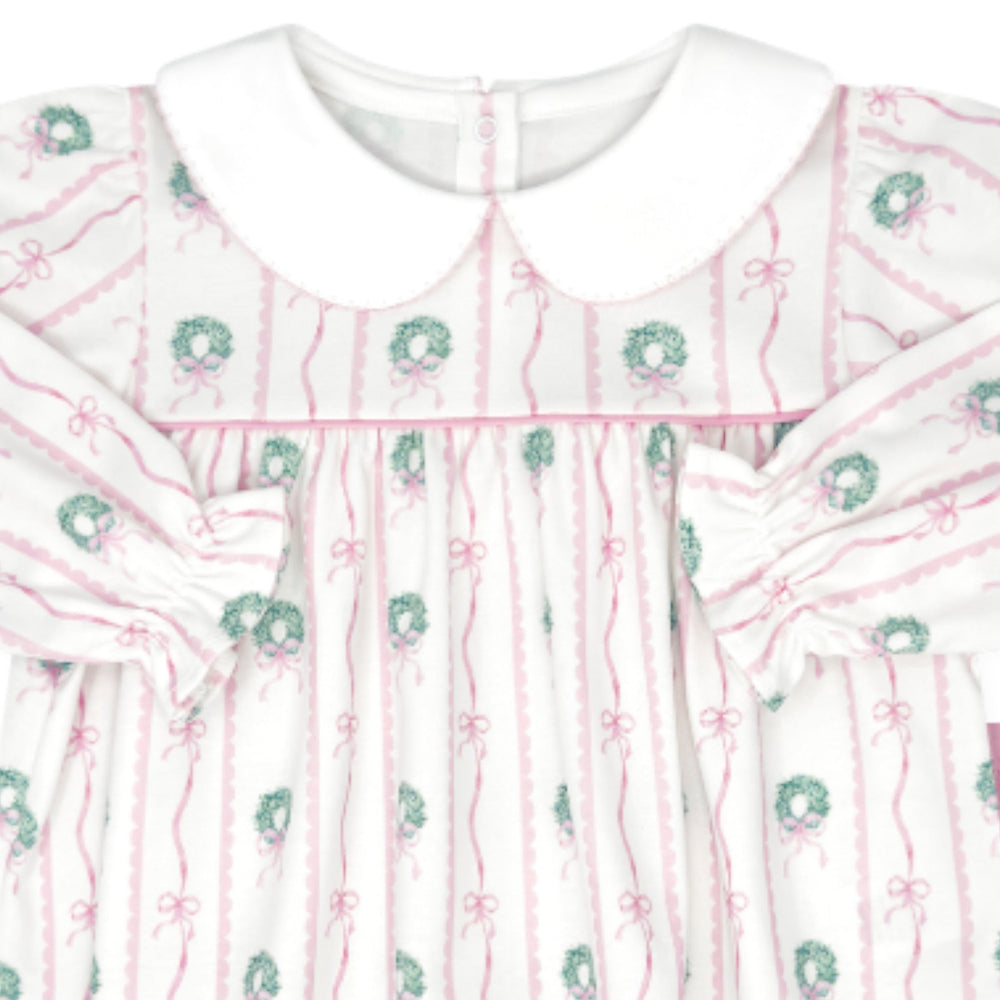 That Store girls swing top featuring a white and pink boxwood wreath and bow print with a classic Peter Pan collar.