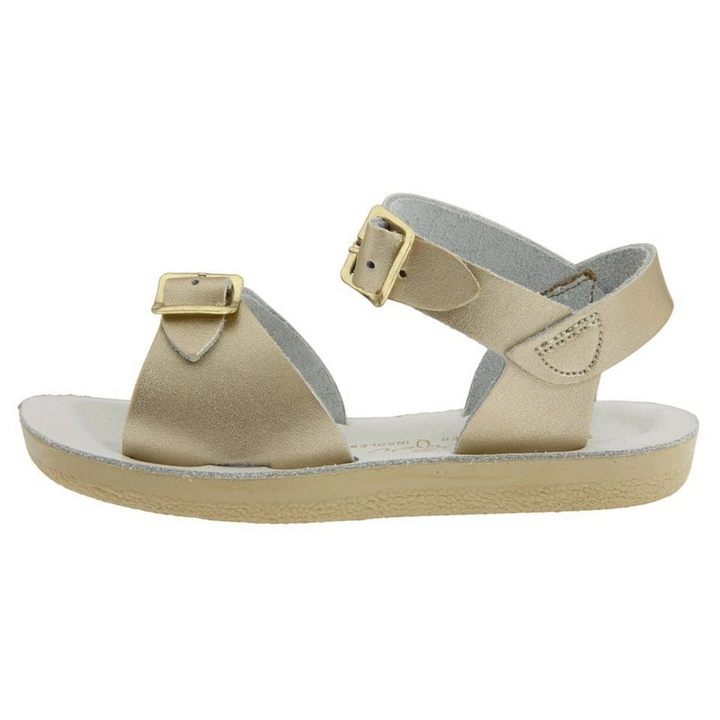 That Store gold leather water-friendly sandals with two adjustable brass buckle straps and a flexible urethane outsole.