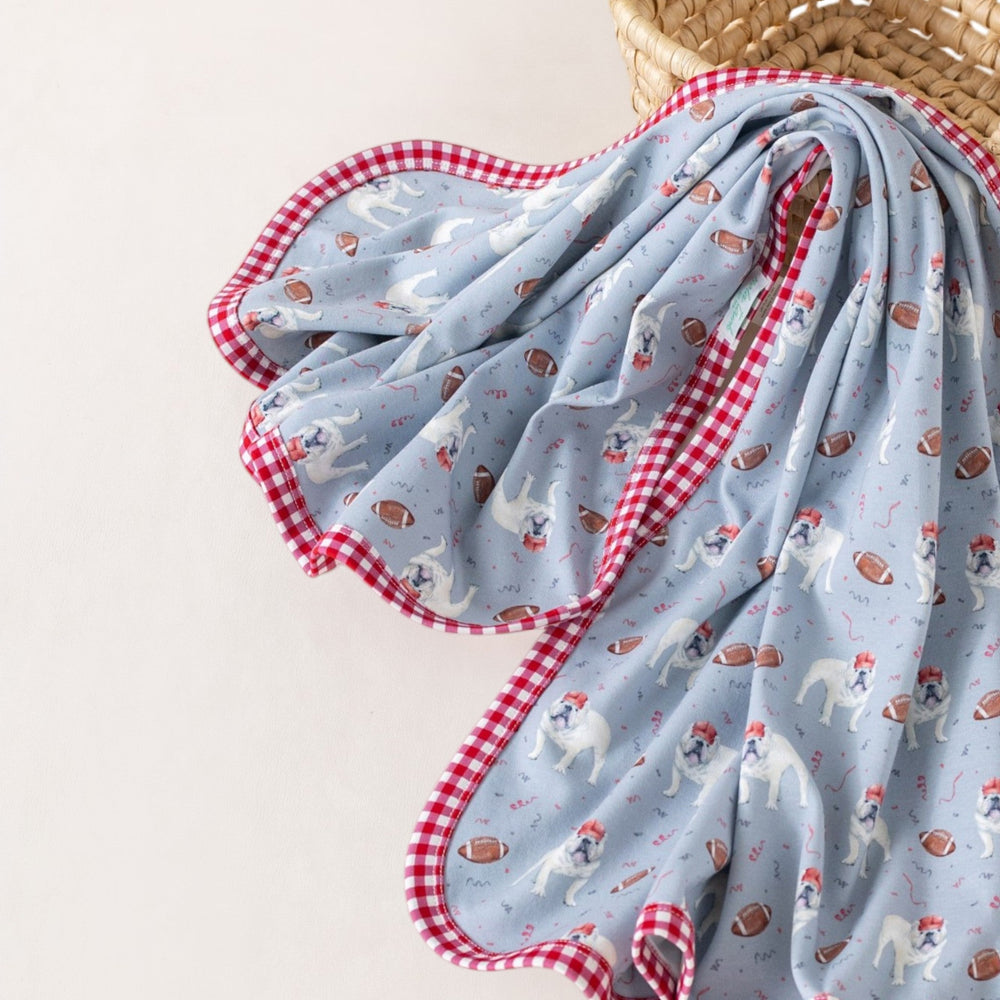 That Store organic cotton swaddle blanket in gray with bulldog and football print and red gingham trim