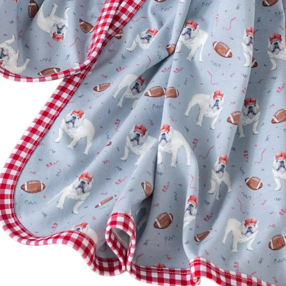 That Store organic cotton swaddle blanket in gray with a bulldog and football print and red gingham trim