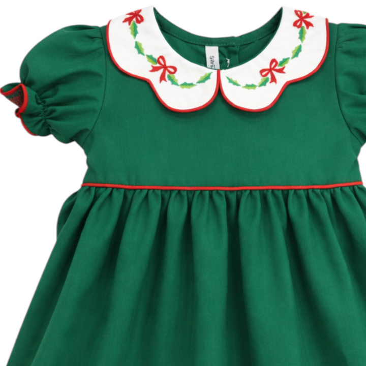 That Store girls green cotton dress featuring a white scallop collar with red bow and holly embroidery for Christmas.