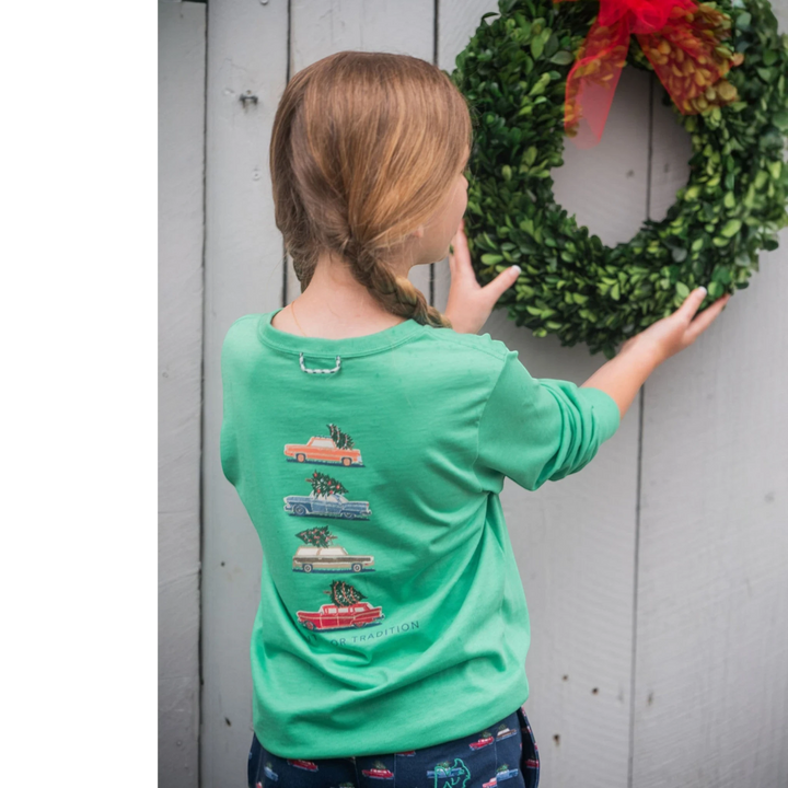 Child wearing a That Store green spruce long sleeve cotton t-shirt with vintage car Christmas tree graphic on back