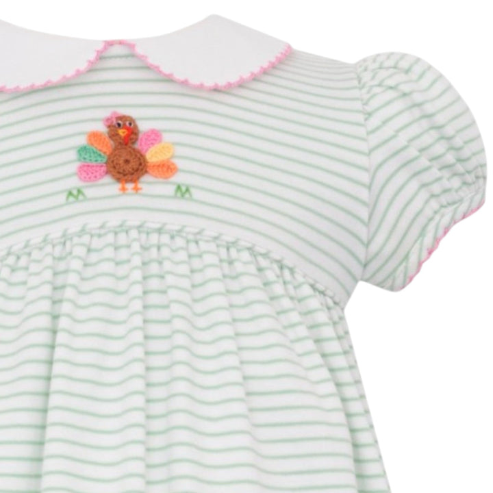 That Store girls green stripe knit dress featuring a cute crochet turkey appliqué and a white peter pan collar.