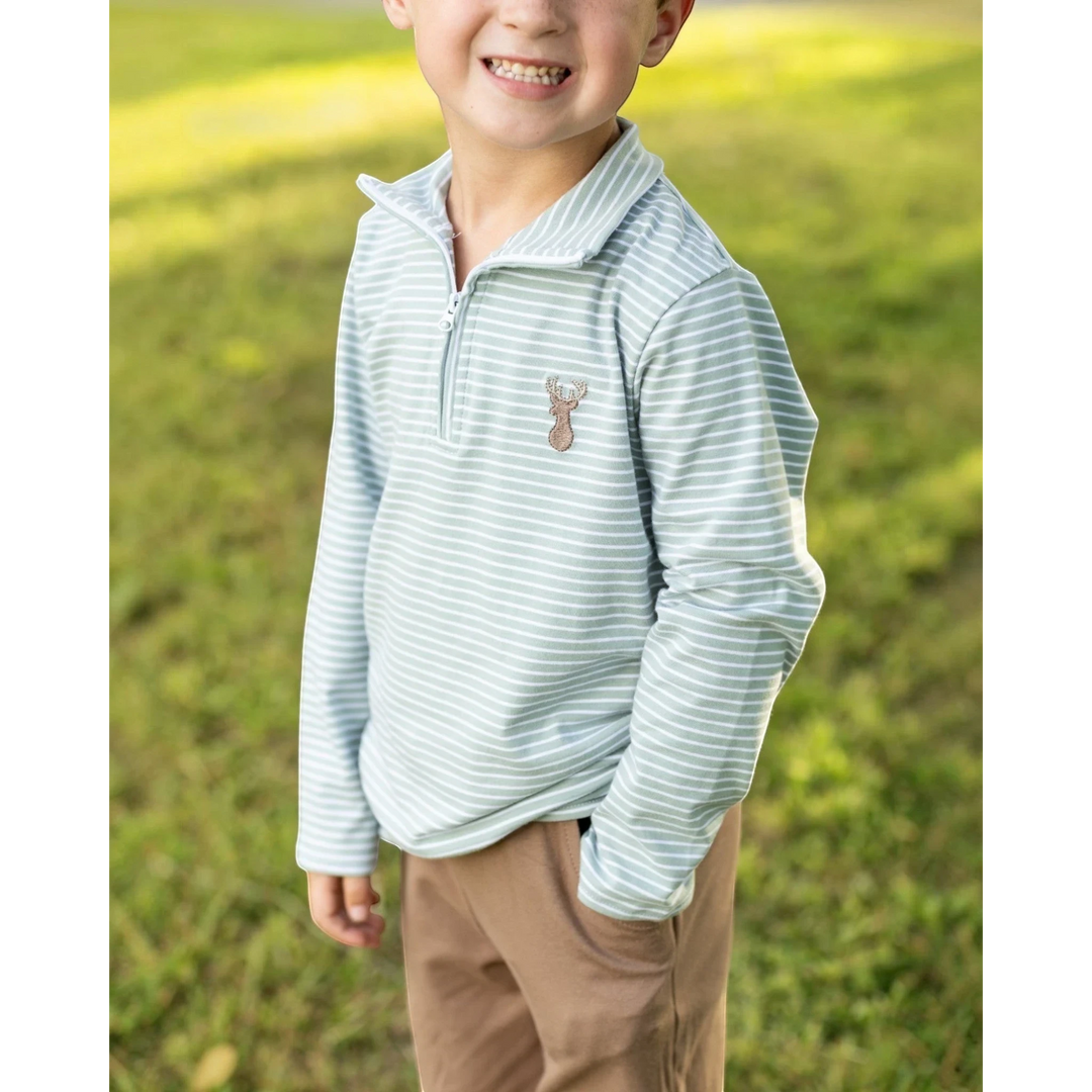 A young boy wearing a That Store green striped quarter-zip pullover with a small deer motif on the chest.